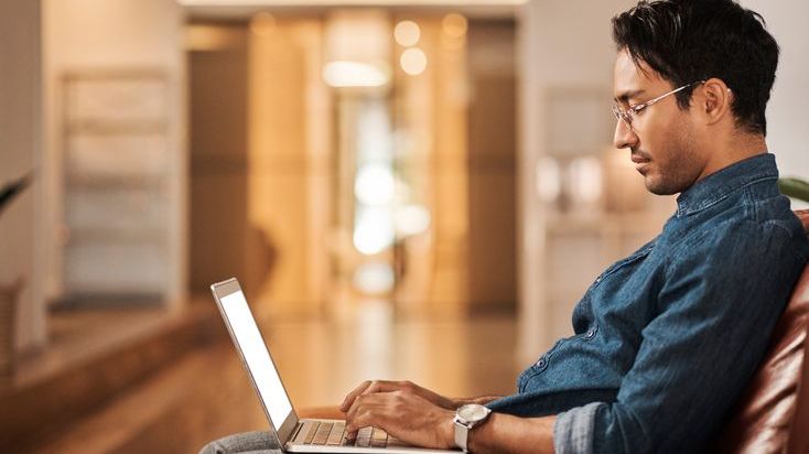 A man researches IRA providers online. 