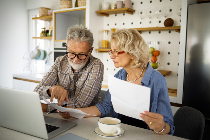 A couple calculating their IRA and 401(k) investments.