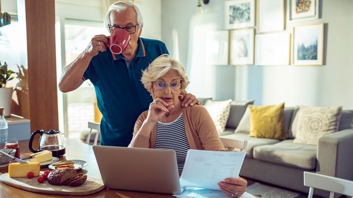 A woman looks over her pension plan documents to determine whether she should take a lump sum payment or series of monthly payments.