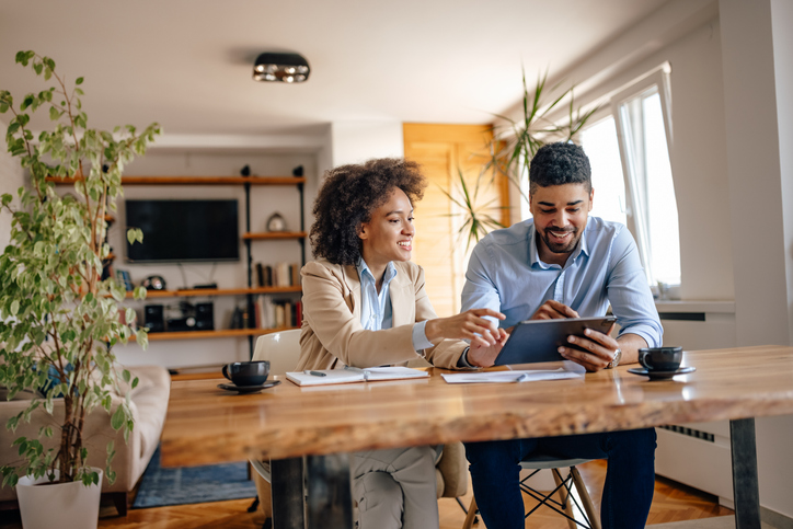 A couple reviewing how much their retirement account has grown over the year.