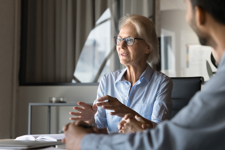 A senior working with a financial advisor to get spousal consent to change a 401(k) beneficiary.